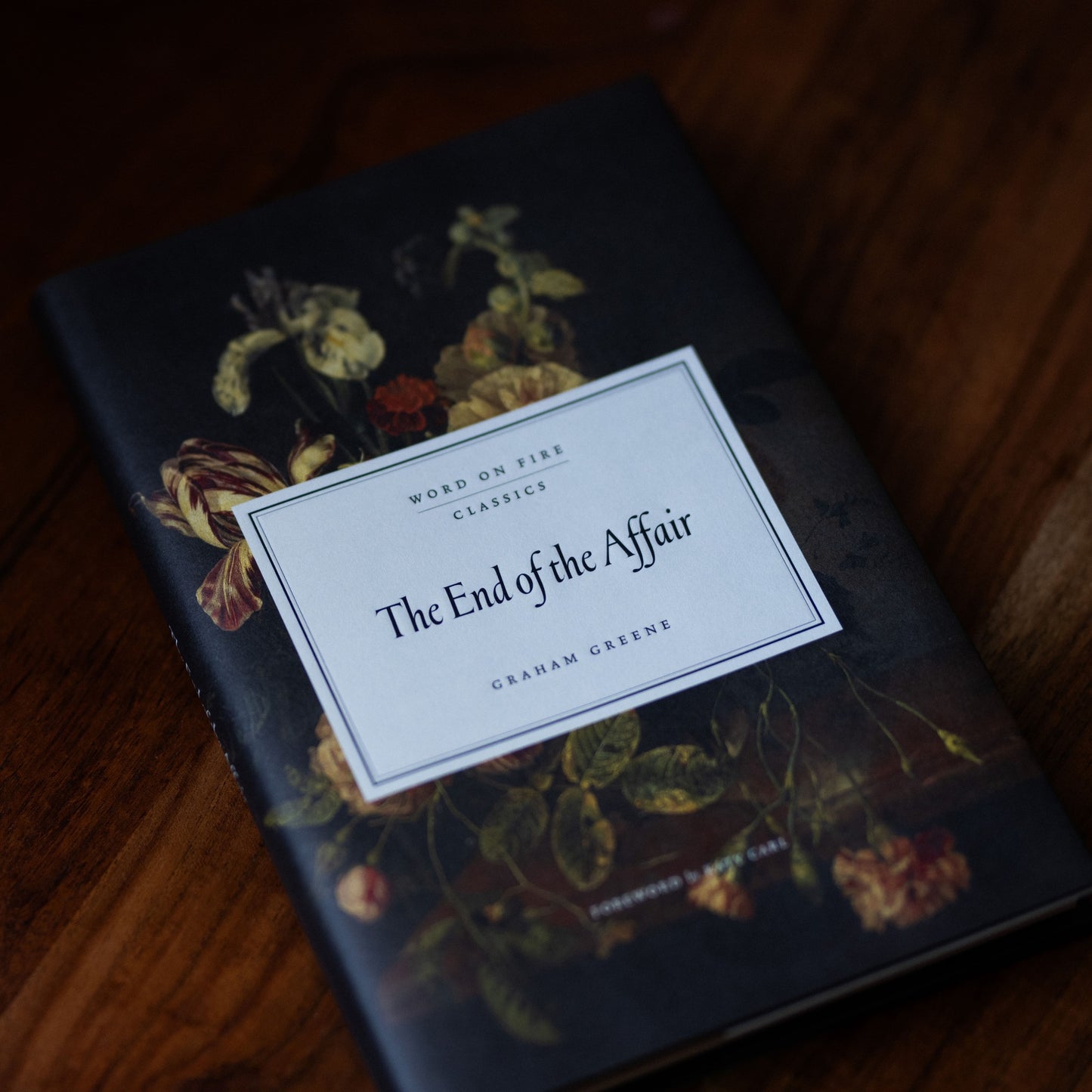 The End of the Affair book with a dark floral cover design, a Word on Fire Classics edition by Graham Greene, hardcover 9781685782511