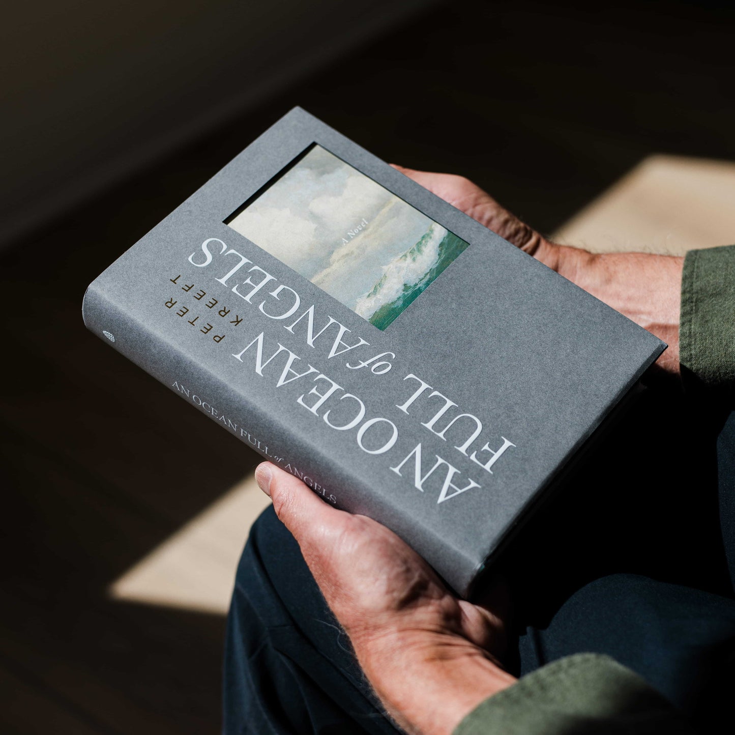 Person holding the book "An Ocean Full of Angels" by Peter Kreeft, Catholic fiction novel, Word on Fire Luminor, hardcover 9781685783075