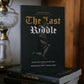 Book titled 'The Last Riddle' by Stephen Smith on a stack of books with a blurred background.