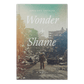 Book cover of 'Wonder + Shame' by Gregory Orfalea with a war-torn cityscape background, published by Word on Fire Luminor
